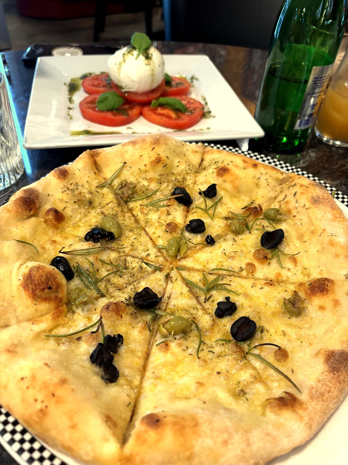 Fresh focaccia with olives and burrata caprese
