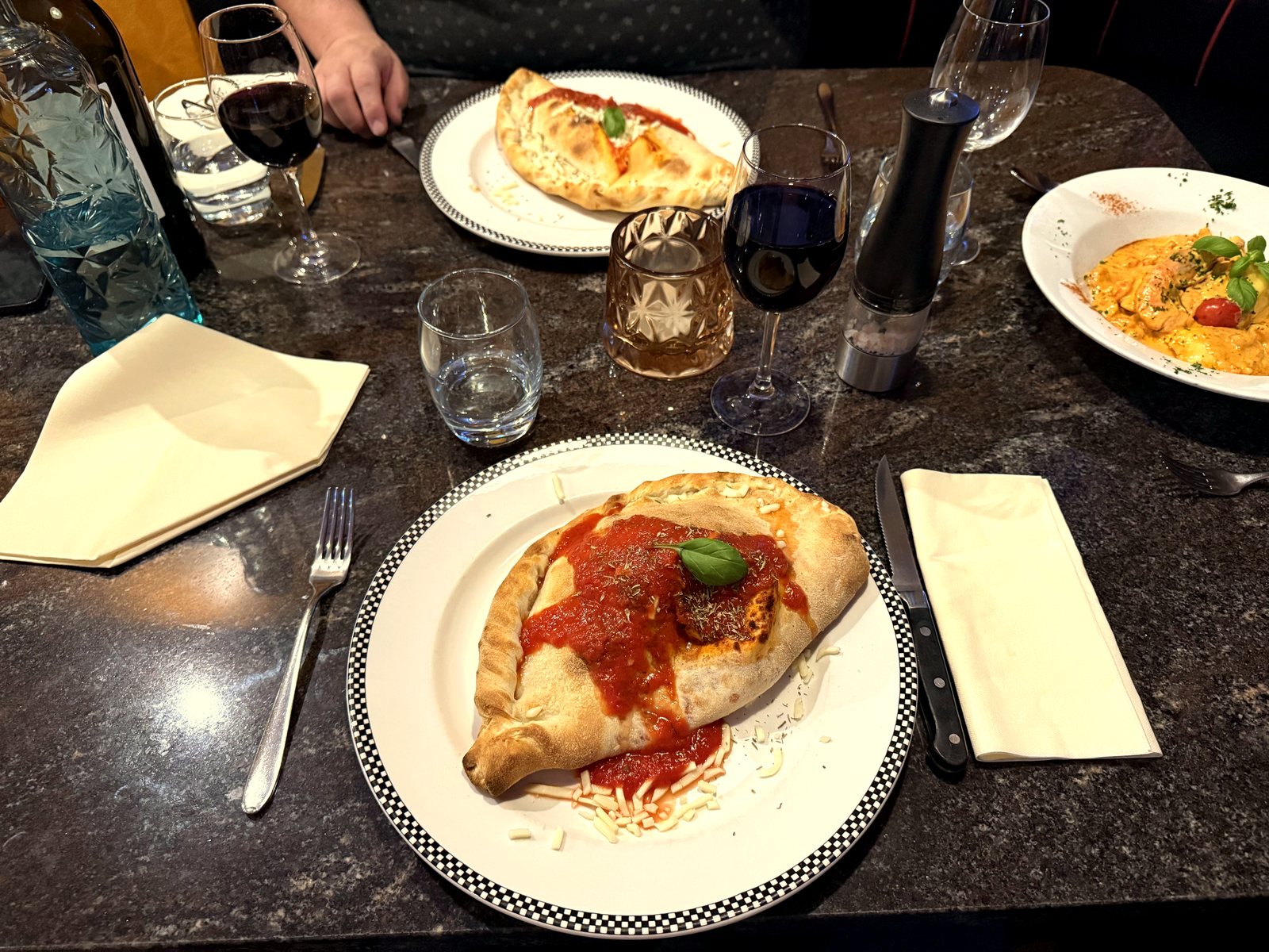 A table set with wine and Italian dishes at Tuscany Too